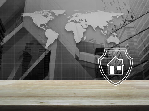 House with shield flat icon on wooden table over black and white world map, city tower and skyscraper, Business home insurance and security concept, Elements of this image furnished by NASA