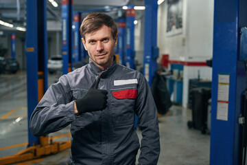 Mechanic in overalls standing in the workshop