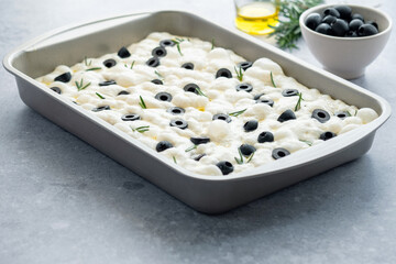 Traditional Italian focaccia bread with rosemary and olives