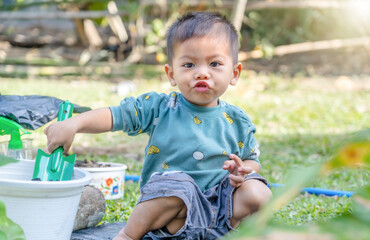 Little child shovels soil into pots to prepare plants for planting. Toddler boy digging soil for planting to Mother's little helper. Gardening. Hobbies at home horticulture. Leisure activities concept