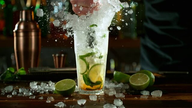 Super slow motion of making mojito cocktail with camera movement. Speed ramp effect. Filmed on high speed cinema camera with cinebot, 1000 fps.