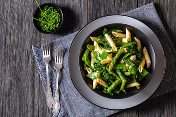 Pasta primavera with green veggies, cheese in bowl