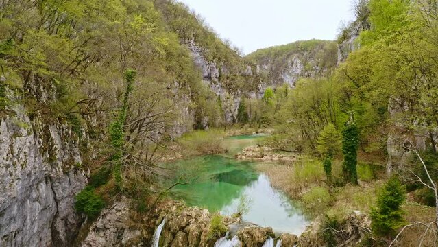 Aerial view Plitvice lakes national park UNESCO lake in Croatia. Drone copter shooting from above Croatian waterfall mountains river trees forest beautiful nature of Europe green landscape tourism