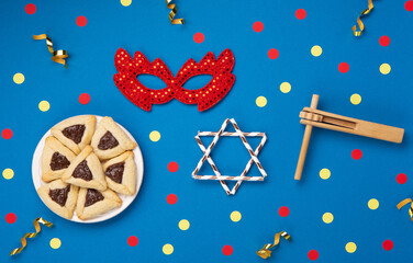 Hamantaschen Cookies, Carnival Mask, Noisemaker on Blue Background. Purim Celebration, Jewish...