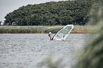 Windsurfer on a windy summertime day at the lake.