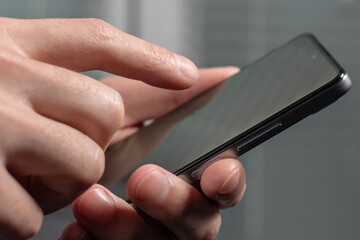Close up of a man using mobile smart phone