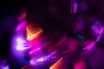Abstract blurred colorful lens flare bokeh on black,