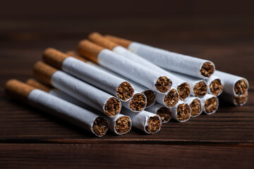 heap of cigarette on a wooden background
