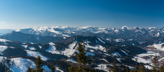 Velka Fatra and Martinske hole in Mala Fatra on the background from hiking trail bellow Skalka hill above Liptovska Luzna village in Low Tatras mountains in Slovakia