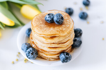 Tasty pancakes with blueberries and honey