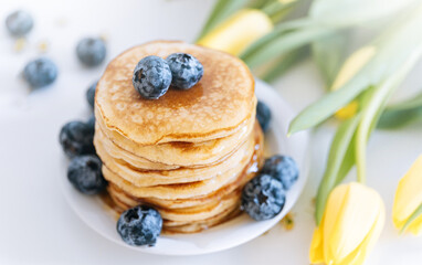 Tasty pancakes with blueberries and honey
