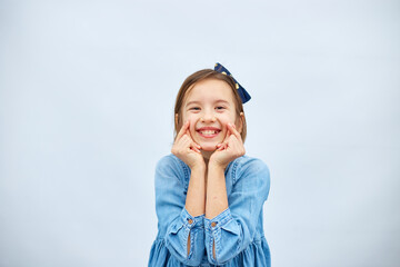 Smiling little girl make trend mini heart sign with fingers