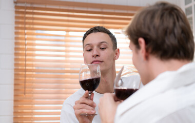 LGBT Young couple celebrate the day of love between each other with fine wine in the kitchen of the house