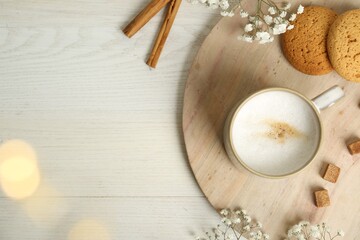 Fototapeta na wymiar Cup of hot coffee, cookies, brown sugar and flowers on white wooden table, flat lay. Space for text