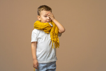 Little sick boy with digital thermometer in mouth on light background. Copy space.