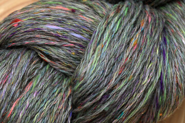 Closeup detail of colourful organic natural handspun and handdyed merino sheep wool yarn , spun on...