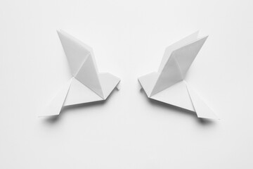 Beautiful origami birds on white background, flat lay