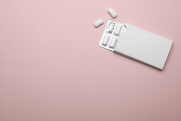 Blister with chewing gums on pink background, top view. Space for text