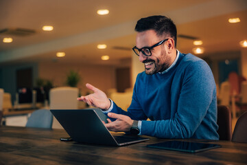 Man boss having an online meeting over the laptop, sitting at the office.