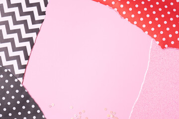 Abstract collage background with copy space.The torn edges of the paper form a frame on a pink background