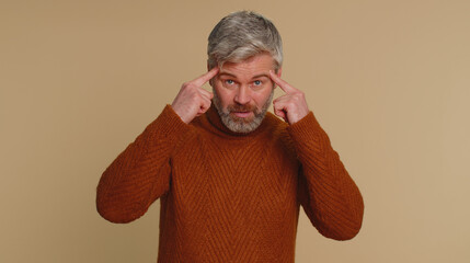 You are crazy, out of mind. Middle-aged elderly old man pointing at camera and showing stupid...