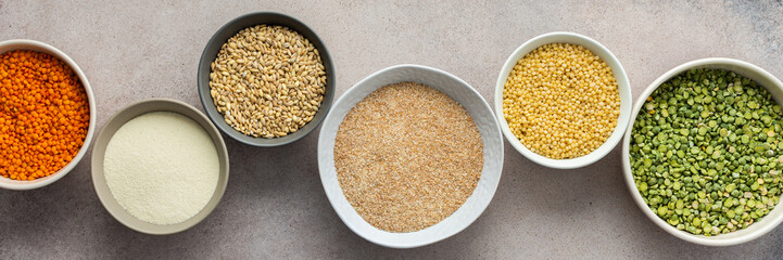 Various grain cereals in bowls banner, top view