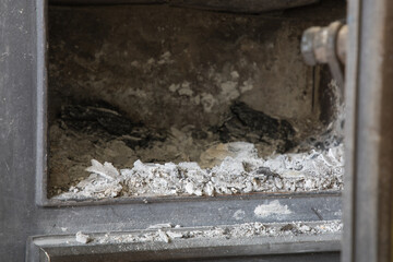 Empty fireplace with a lot of ash inside