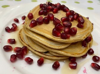 pancakes with pomegranate and maple syrup