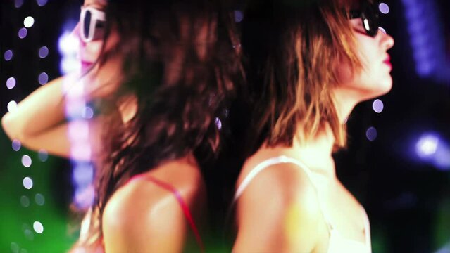 Female friends dancing at night club