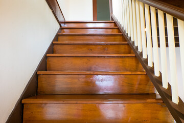 Wooden stairs inside contemporary white house.