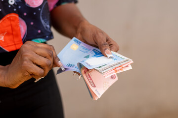 young african businesswoman counting a lot of money