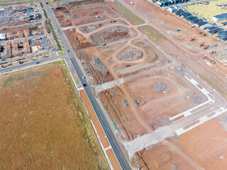 Aerial view of cleared land blocks in an urban subdivision