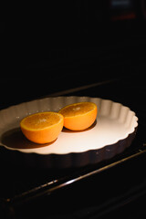 halves of roasted oranges in the oven