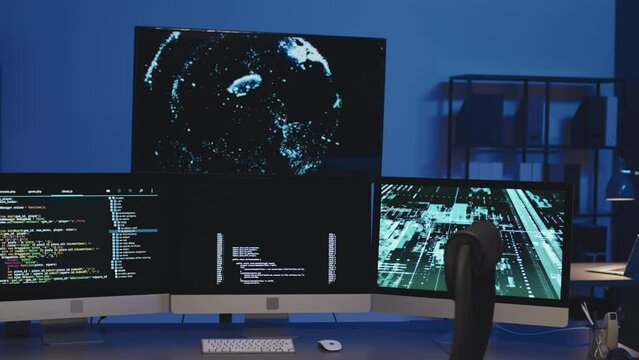 Medium shot of workplace of IT specialist with computer monitors with codes on the screen to develop new software