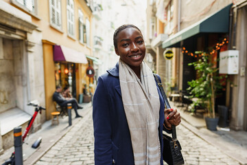 Young african woman walks alone on europe street