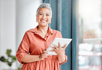 Tablet, portrait and senior business woman in office, research or internet browsing. Technology, smile or happy female ceo with touchscreen by window for networking, social media or web scrolling