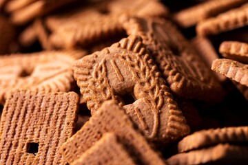 Fototapeta na wymiar Multiple brown cookies called speculaas or speculoos in Belgium or the Netherlands. The spiced biscuit is very delicious and popular during the winter period to be eaten at any time.