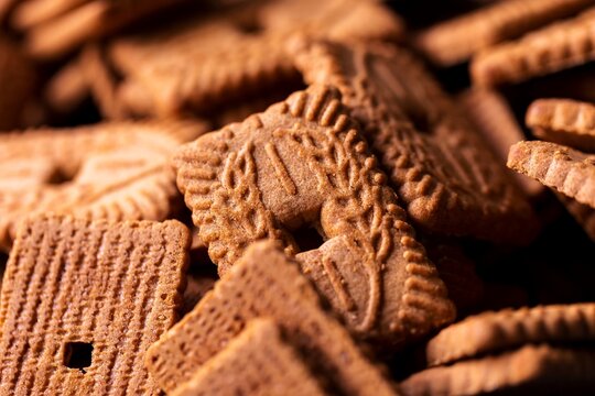 Multiple brown cookies called speculaas or speculoos in Belgium or the Netherlands. The spiced biscuit is very delicious and popular during the winter period to be eaten at any time.