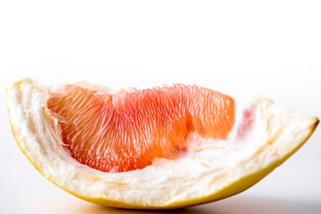 Pomelo on a white background.Advertising pomelo.Grapefruit.Pomelo pink. Fruit isolated.Cut pomelo on white background.Pomelo macro shot.Grapefruit macro shot.Juice drops on the fruit. fruit macro shot