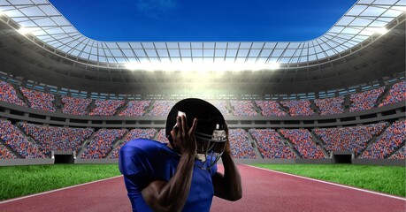 Composition of male american football player holding his helmet over sports stadium