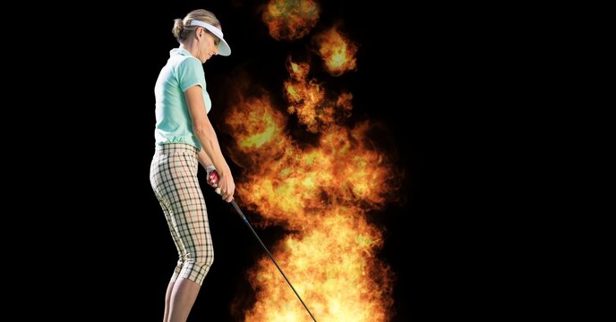 Composition of female golf player over flames on black background