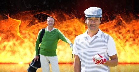 Portrait of two diverse senior male golf player against fire flame effect on black background