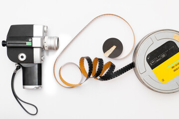 old 8mm film camera and film roll on white background.