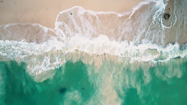 Aerial view of the waves splashing to the beach.