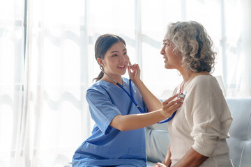 Young asian caretaker with 60s asia elderly woman consulting and encourage, take a history and...