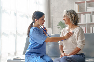 Young asian caretaker with 60s asia elderly woman consulting and encourage, take a history and...