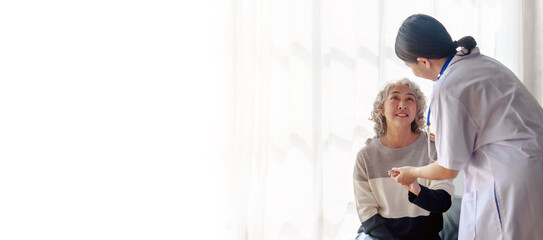 Young asian caretaker with 60s asia elderly woman consulting and encourage, take a history and...