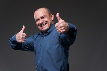 Happy businessman on gray background