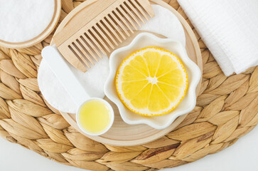 Lemon slice, lemon juice and wooden hairbrush. Ingredients for preparing homemade hair toner or...