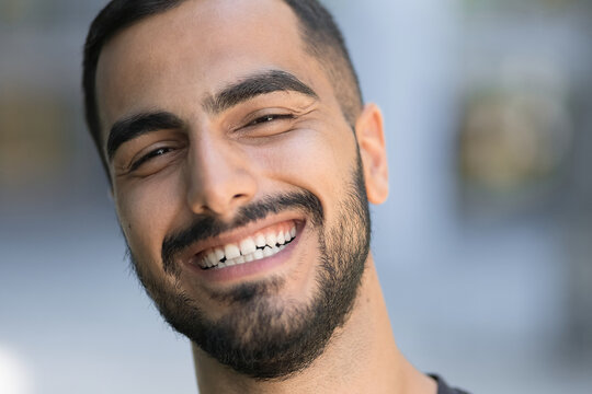 Portrait of happy iranian confident man laughing and looking at camera 